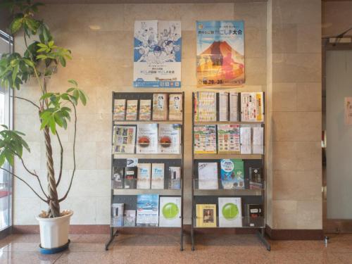 a book shelf in a room with books on it at Sun Hotel Kokubu - Vacation STAY 62468v in Kirishima