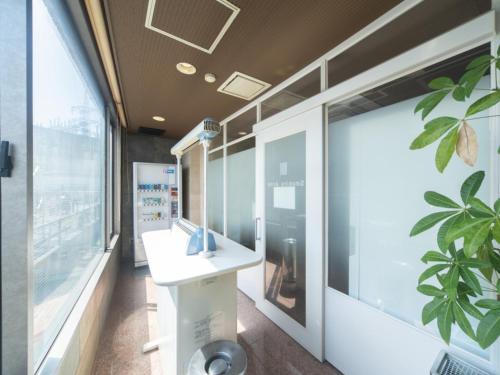 a bathroom with a sink and a window at Sun Hotel Kokubu - Vacation STAY 62468v in Kirishima