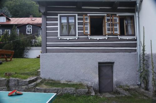 a small house with a door and a window at Chalupa Bílá Desná in Jablonec nad Nisou