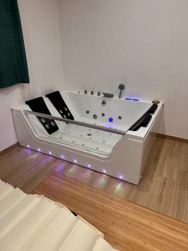 a bath tub sitting on top of a wooden floor at RG MAISON - Suite 29 in Morino