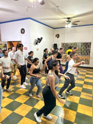 a group of people dancing in a room at Havana Dance School & Hostel in Cali