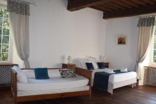 a living room with two beds and a couch at Elégance Périgourdine and SPA in Sainte-Sabine