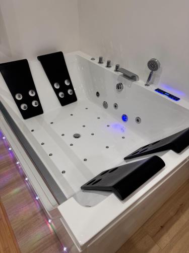 a bathtub with black and white ingrediants at RG MAISON - Suite 29 in Morino