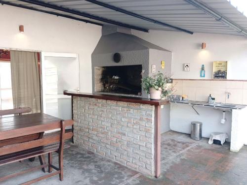 a kitchen with a brick fireplace in a room at Entre naturaleza a 1 cuadra de la playa/Jacuzzi in Salinas 
