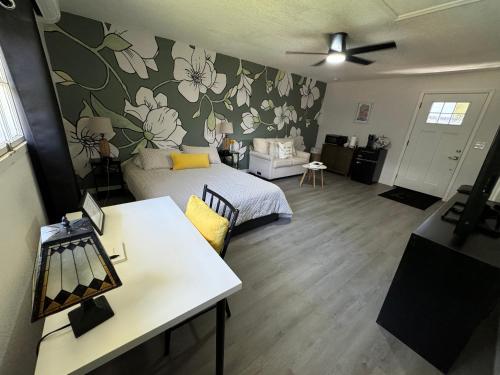 a living room with a bed and a table in a room at The Sanford Foodie Guest House in Sanford