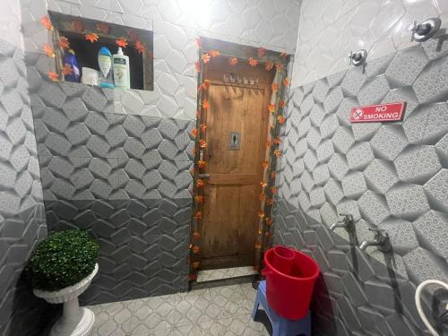 a bathroom with a door with a sign on it at Eye love peace cafe in Manīkaran