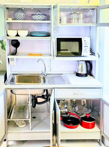 an open refrigerator with a sink and a microwave at Beach Front Queen's Castle - Kid friendly, Holiday like Royalty in Ban Ao Makham