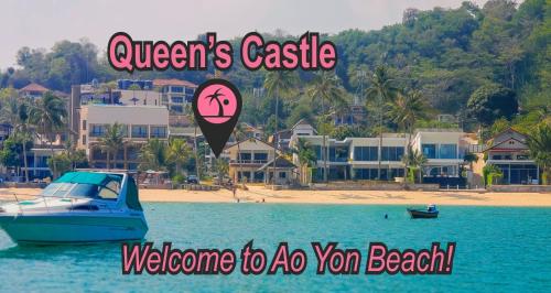 a boat in the water next to a beach at Beach Front Queen's Castle - Kid friendly, Holiday like Royalty in Ban Ao Makham