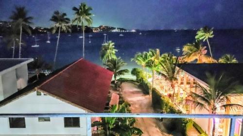 a view of the ocean from the balcony of a resort at Beach Front Queen's Castle - Kid friendly, Holiday like Royalty in Ban Ao Makham
