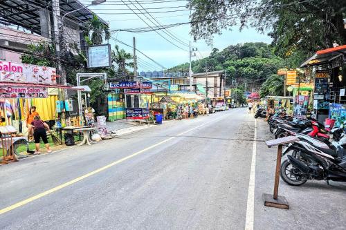 a street with motorcycles parked on the side of the road at Beach Front Queen's Castle - Kid friendly, Holiday like Royalty in Ban Ao Makham