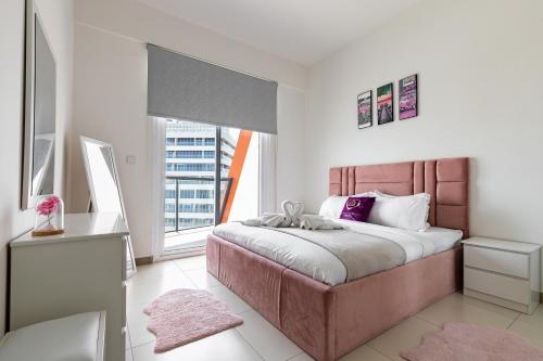 a bedroom with a large bed and a large window at Simply Comfort Vacation Homes Rental Binghatti Gateway Family 2BR with Balcony, Close to Dubai Mall & Burj Khalifa in Dubai
