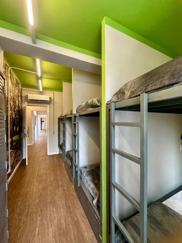 a room with bunk beds with a green ceiling at Hostel Distrito 011 in Sao Paulo