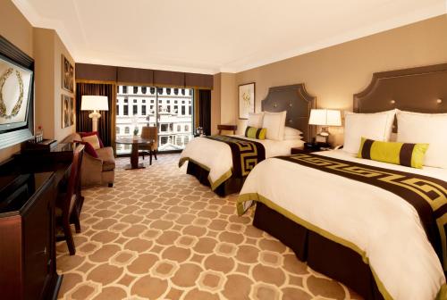 a hotel room with two beds and a television at Caesars Palace Hotel & Casino in Las Vegas