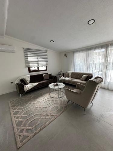 a large living room with couches and a table at Beach Suites - İçmeler in Icmeler