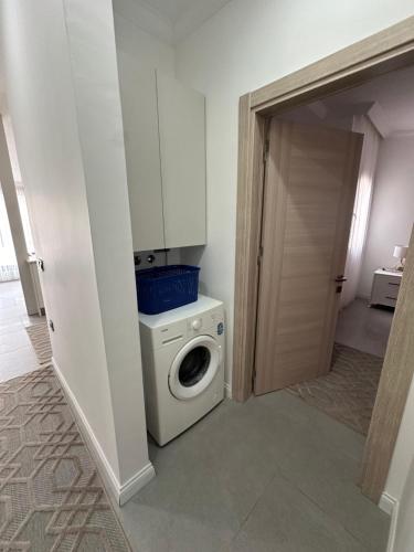 a bathroom with a washing machine and a washer at Beach Suites - İçmeler in Icmeler