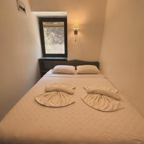 two pillows on a bed in a room at Beach Suites - İçmeler in Icmeler