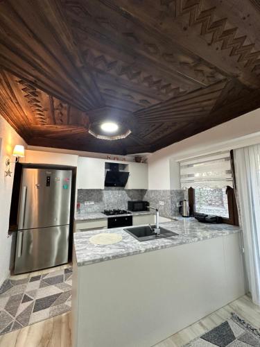a kitchen with a stainless steel refrigerator and a sink at Beach Suites - İçmeler in Icmeler