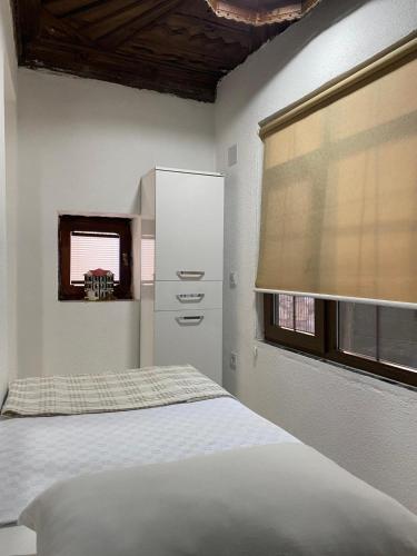 a bedroom with a bed and a dresser and a window at Beach Suites - İçmeler in Icmeler
