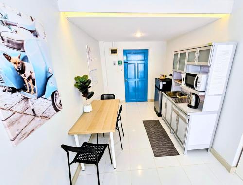 a kitchen and dining room with a table and a microwave at Beach Front Queen's Castle - Kid friendly, Holiday like Royalty in Ban Ao Makham