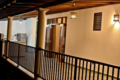 a balcony of a house with a railing and lights at Sandun Villas in Unawatuna