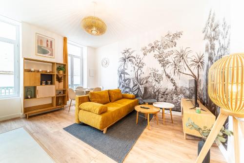 un salon avec un canapé et une table dans l'établissement Le Marietton appartement cosy à deux pas du métro Valmy, à Lyon