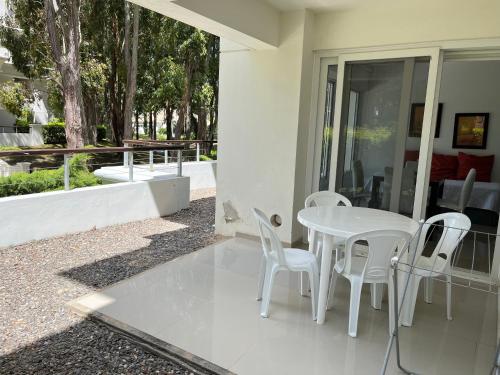 a white table and chairs on a patio at Green Park Punta 2 in Punta del Este