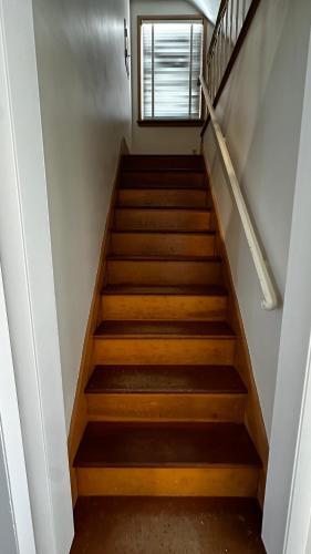 a staircase in a house with a window at Peoria Bradley Cozy Vacation Large Group Home with Kitchen View in Peoria