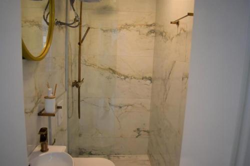 a bathroom with a shower with a toilet and a sink at Moco - Novalja in Novalja