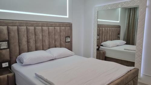 a bedroom with two beds and a mirror at Moco - Novalja in Novalja