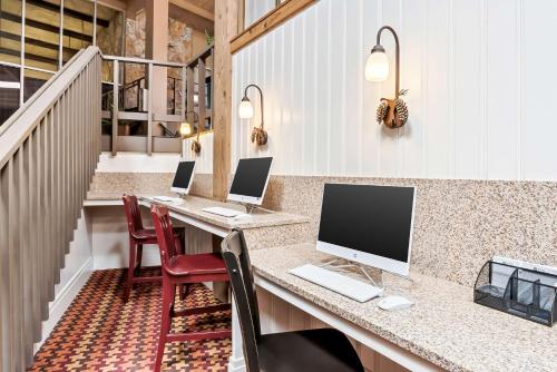 a room with a desk with two computers on it at Best Western Outlaw Inn in Rock Springs