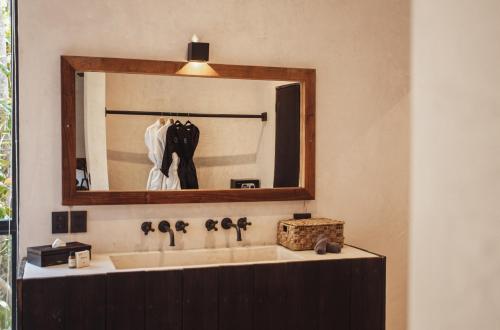 a bathroom with a sink and a mirror at UMi Tulum in Tulum