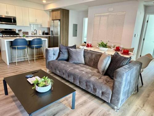a living room with a couch and a table at Corner 2 Bedroom 2 Bath Condo - Balcony - Parking in Los Angeles