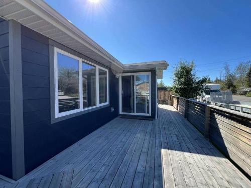 a house with a wooden deck with windows at Little Holiday Home in Yellowknife