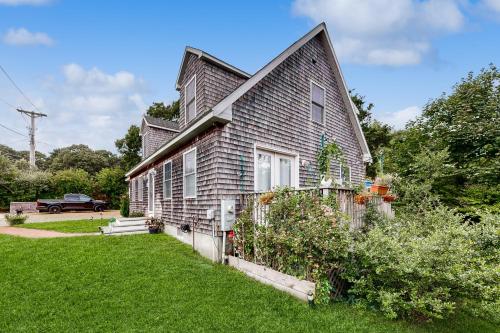 a gray house with a fence in the yard at Bird Street Breeze in Oak Bluffs