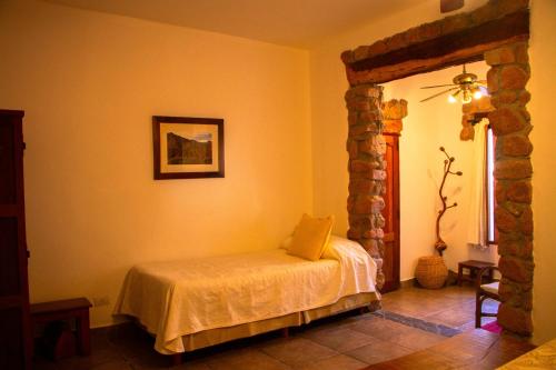 Postel nebo postele na pokoji v ubytování Hotel Killa Cafayate
