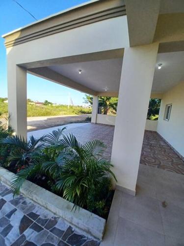 a house with a patio with plants in it at Villa Xiomara in El Jamo