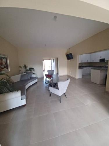 a large living room with a couch and a chair at Villa Xiomara in El Jamo