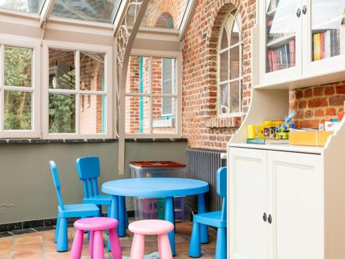 a kitchen with a blue table and chairs at Alverwege in Baerle Heide