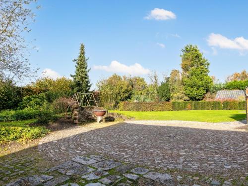 a cobblestone driveway with a garden in the background at Alverwege in Baerle Heide