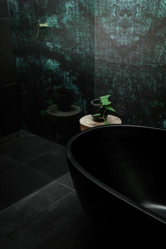 a bathroom with a bath tub and a sink at The Little Terrace House Richmond in Melbourne
