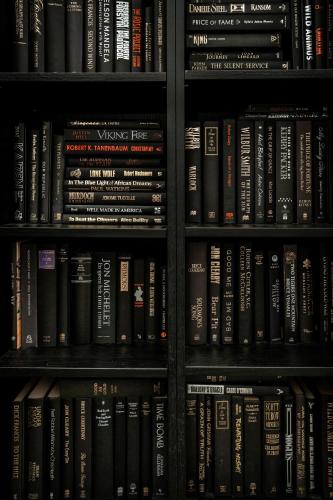 a book shelf filled with lots of books at The Little Terrace House Richmond in Melbourne