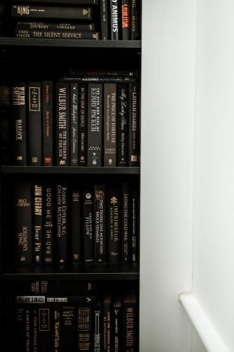 a book shelf filled with lots of books at The Little Terrace House Richmond in Melbourne