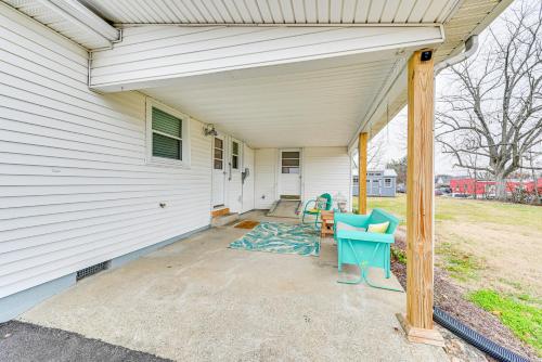a porch of a house with a table and chairs at Charming Cave City Vacation Rental with Fire Pit! in Cave City