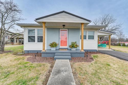 a small house with two potted plants in front of it at Charming Cave City Vacation Rental with Fire Pit! in Cave City
