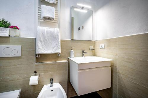 a bathroom with a sink and a toilet and a mirror at Il Viaggiator Leggero in Florence