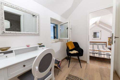 a bedroom with a desk and a chair and a bed at Family friendly house with a swimming pool Cove Zarace, Hvar - 23502 in Hvar