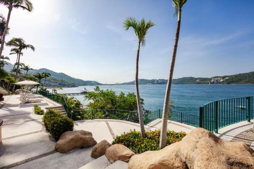 a view of the water from a resort with palm trees at Camino Real Acapulco Diamante in Acapulco