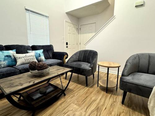 a living room with a couch and two chairs and a table at Bright Spacious Renovated Home Master on Main in Winder