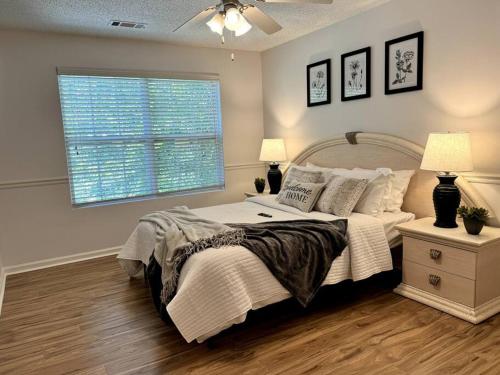a bedroom with a large bed and a window at Bright Spacious Renovated Home Master on Main in Winder