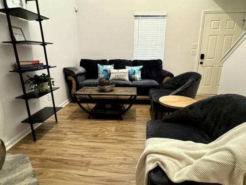 a living room with a couch and a table at Bright Spacious Renovated Home Master on Main in Winder